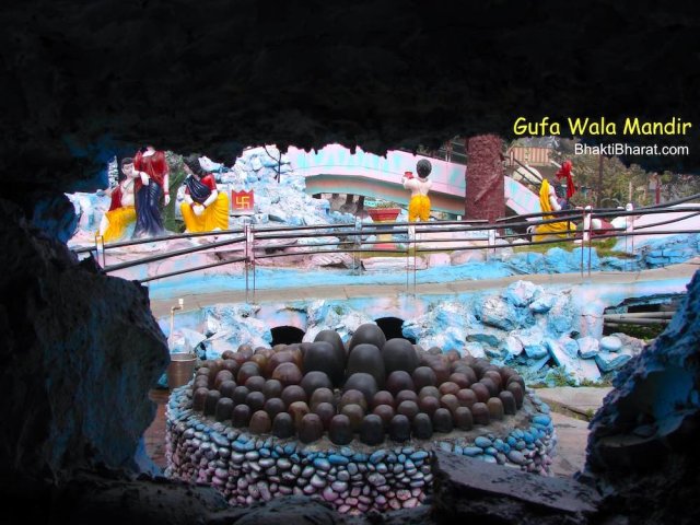 A amazing view of black smooth marble stones while entering gufa(cave). This frame visualize, a no of Shivlings are placed in small circular area.