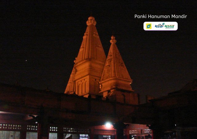 Top of the two temple shikhar out of three, with night lighting effects within the temple boundary.